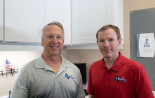 The Handpiece Express repair technicians stand together and smile.