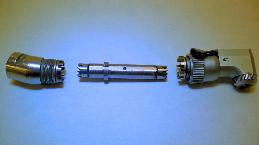 A handpiece latch angle that has been disassembled during routine maintenance.
